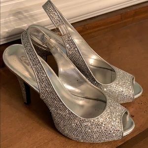 Sparkling silver open toe platform heels.